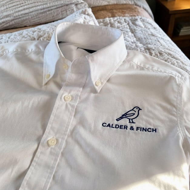 Customer photo of a custom dress shirt on a bed